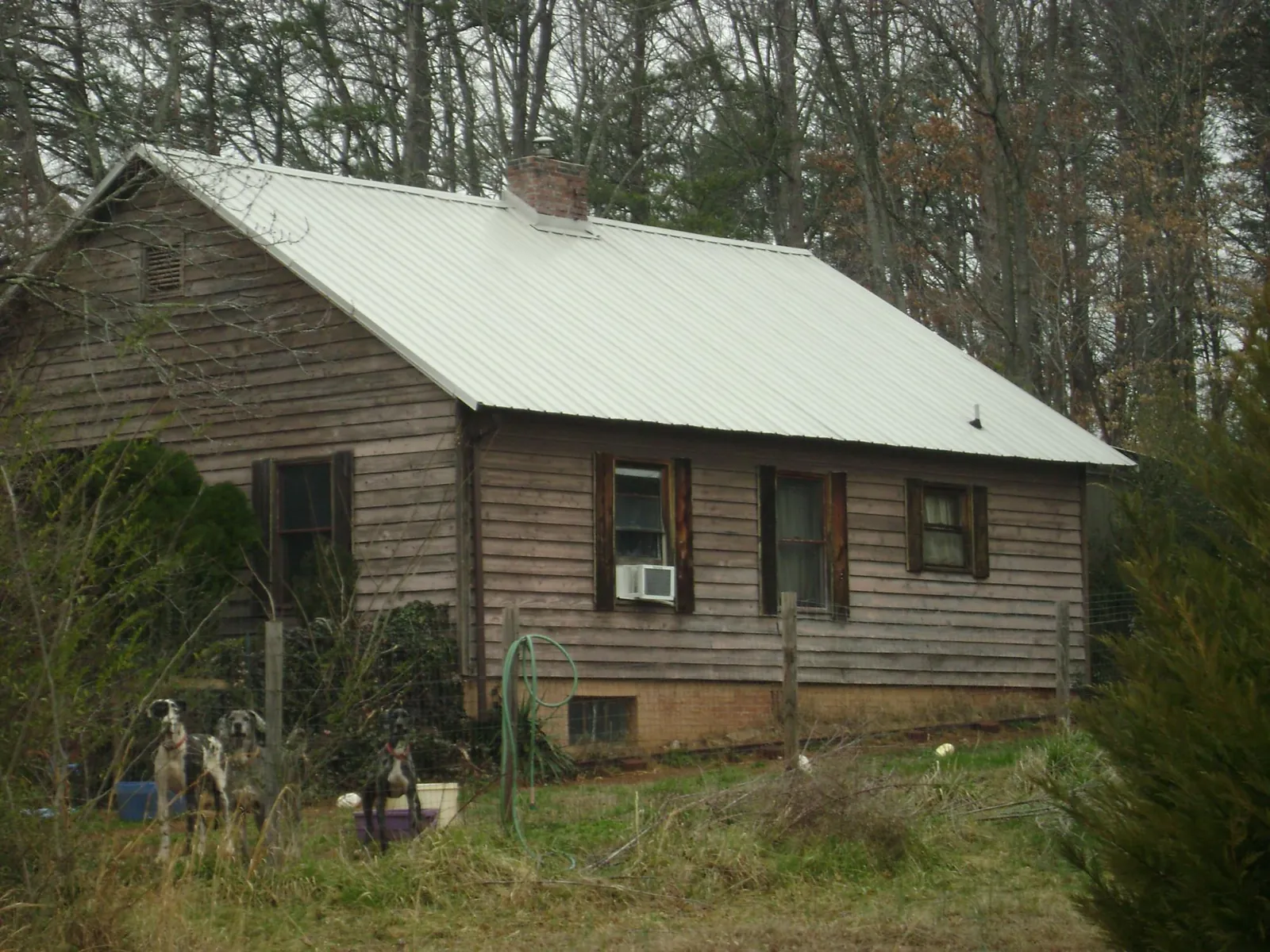 White metal roof on an old wood sided farmhouse, from a Metal Roof Installation job in Fayette City